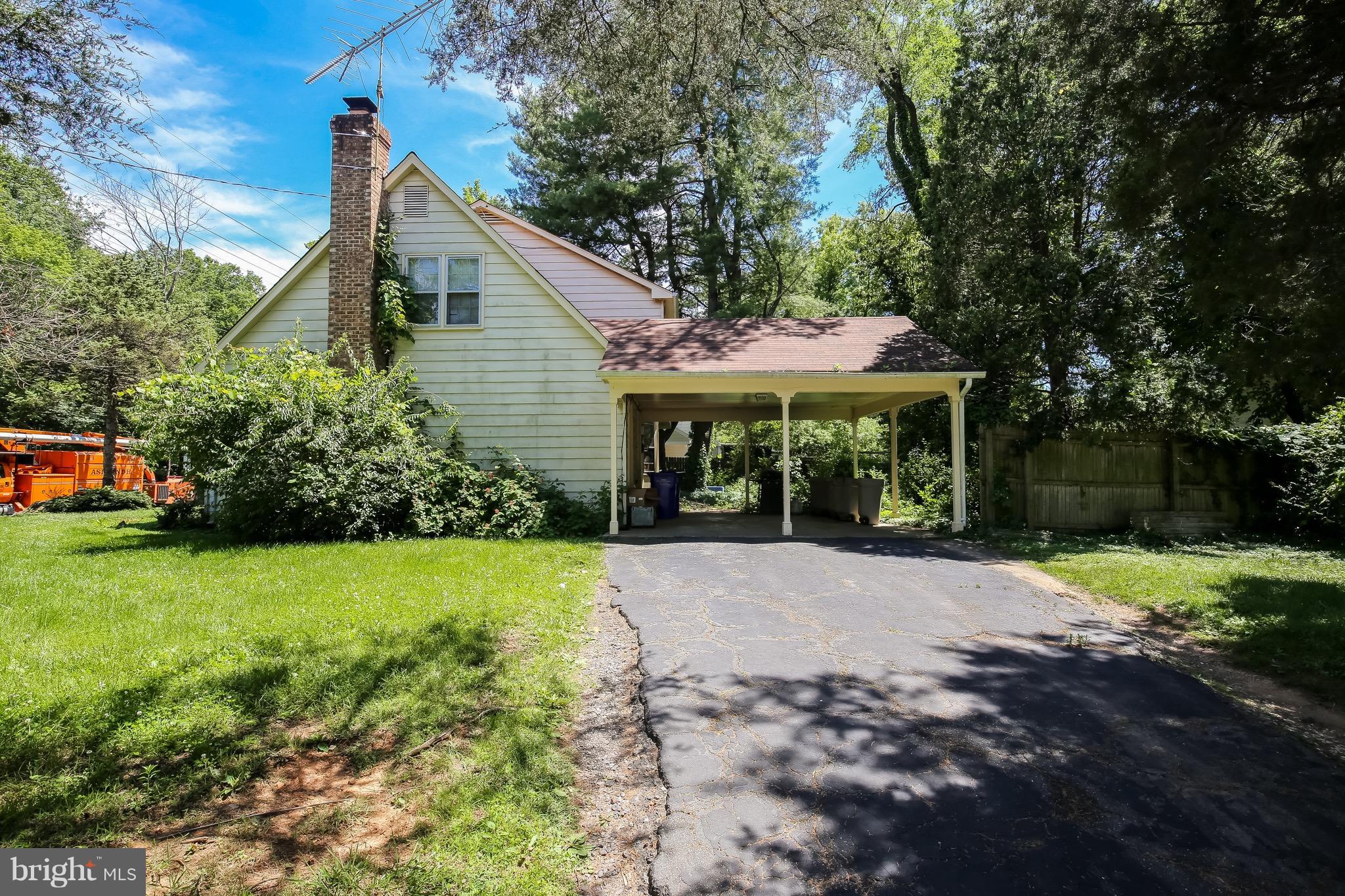 11514 Seven Locks Road Rockville, MD 20854 - Photo 9 of 10 a view of a house with a yard and potted plants