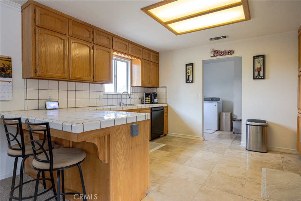 30142 Revis Road Coarsegold, CA 93614 - Photo 11 of 43 a kitchen with granite countertop a sink and cabinets