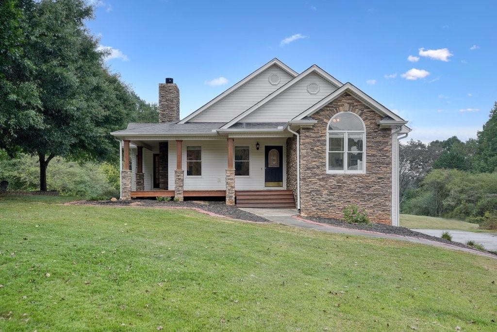 1195 Avery Road Canton, GA 30115 - Photo 1 of 1 a front view of a house with yard and green space