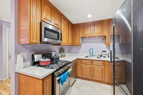 a kitchen with stainless steel appliances granite countertop a sink stove and cabinets