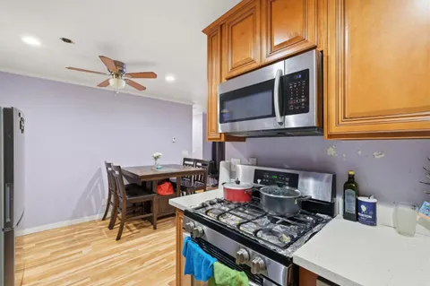 a kitchen with stainless steel appliances granite countertop a stove and a microwave