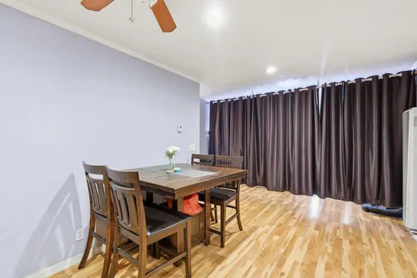 a view of a dining room with furniture and wooden floor