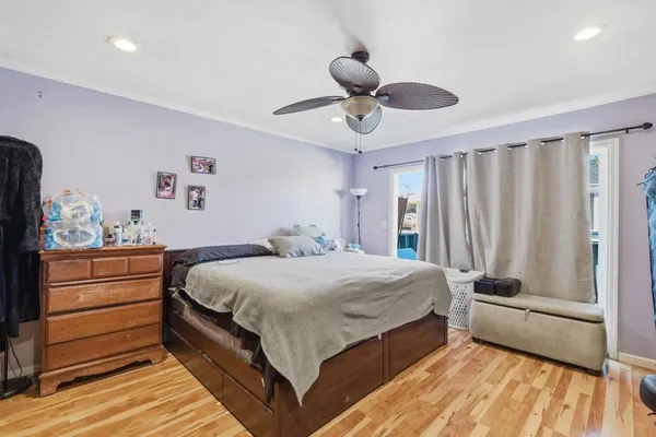 a bedroom with a bed chandelier and a window