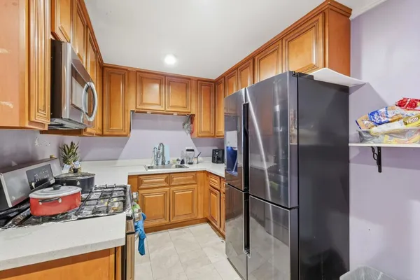 a kitchen with stainless steel appliances granite countertop a refrigerator and a sink