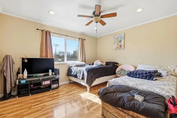 a bedroom with two beds and a flat screen tv