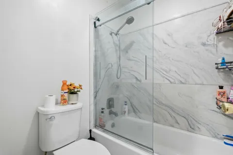 a bathroom with a bathtub and a shower