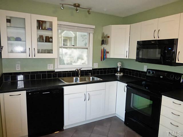 737 Benchmark Drive Raleigh, NC 27615 - Photo 3 of 14 a kitchen with a sink stove and microwave