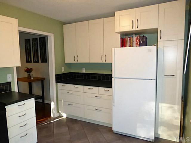 737 Benchmark Drive Raleigh, NC 27615 - Photo 4 of 14 a white refrigerator freezer sitting in a kitchen