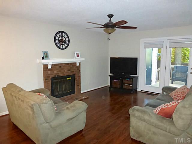 737 Benchmark Drive Raleigh, NC 27615 - Photo 5 of 14 a living room with furniture a flat screen tv and a fireplace
