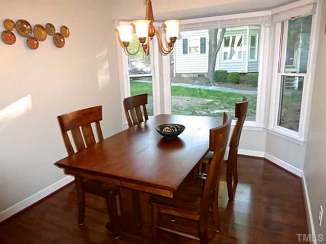 737 Benchmark Drive Raleigh, NC 27615 - Photo 7 of 14 a view of a dining room with furniture window and wooden floor