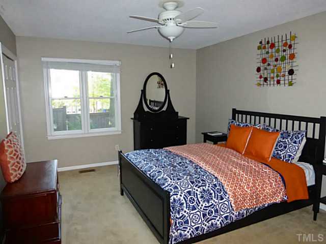 737 Benchmark Drive Raleigh, NC 27615 - Photo 8 of 14 a bed sitting in a bedroom next to a window