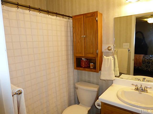 737 Benchmark Drive Raleigh, NC 27615 - Photo 9 of 14 a bathroom with a sink mirror toilet and shower