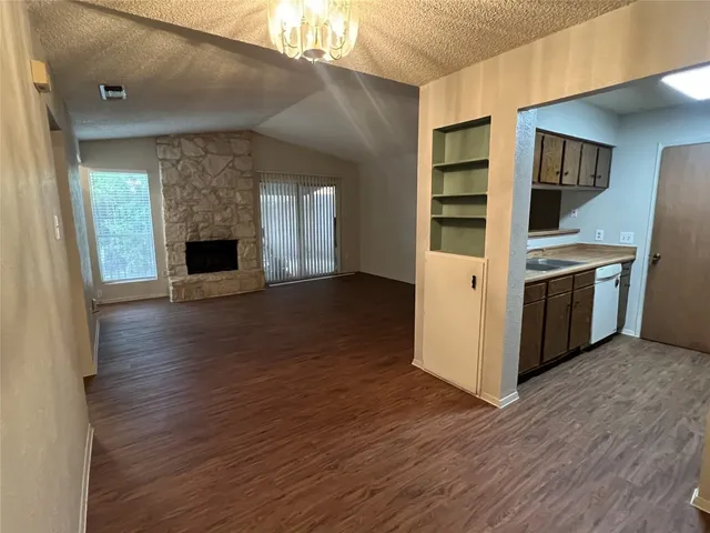 an empty room with a ceiling fan and window