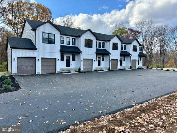 a view of multiple houses with a street