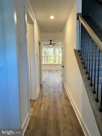 a view of hallway with wooden floor
