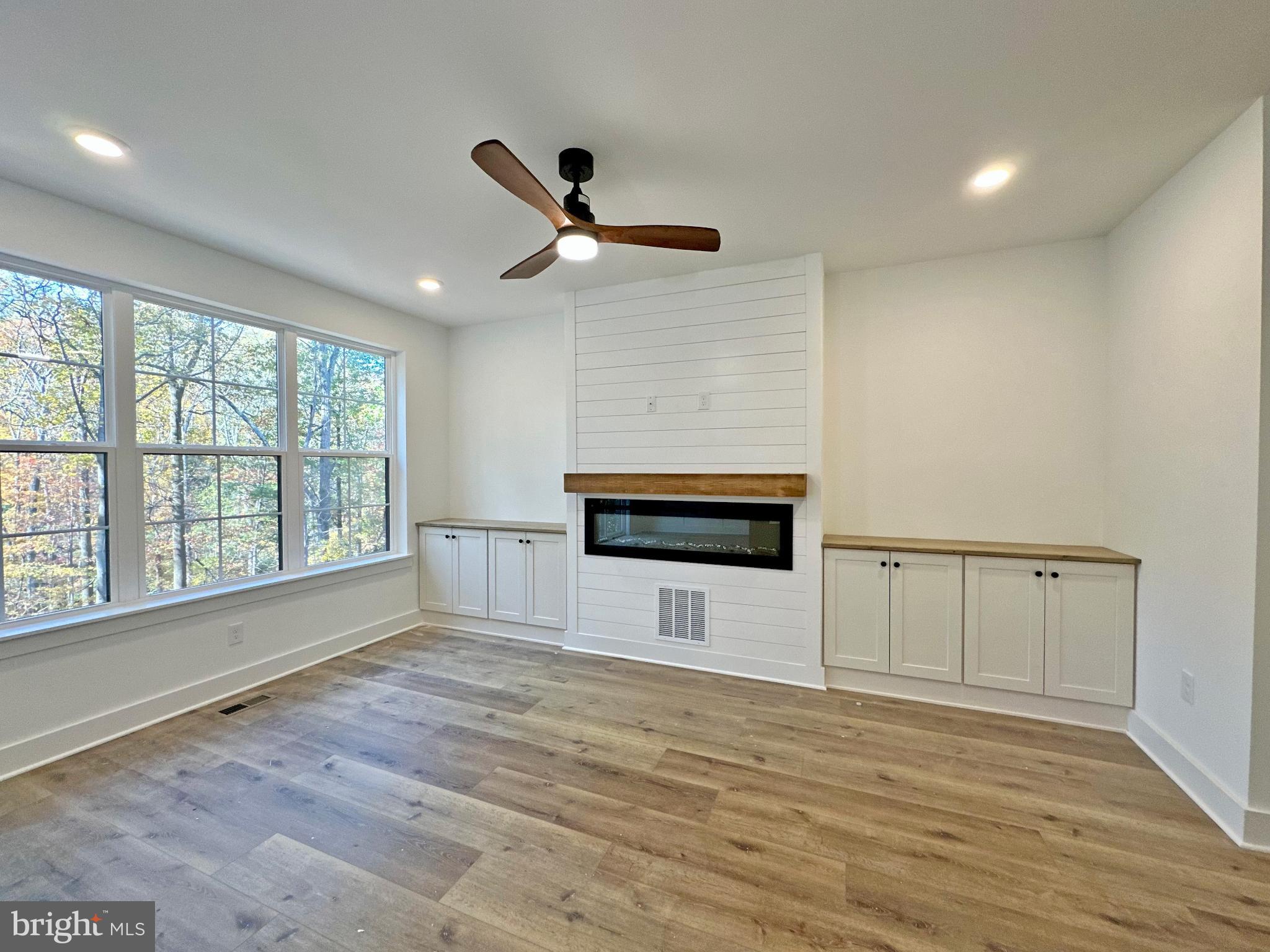 1024 Trinity Road York, PA 17408 - Photo 5 of 17 a view of an empty room with a window and wooden floor