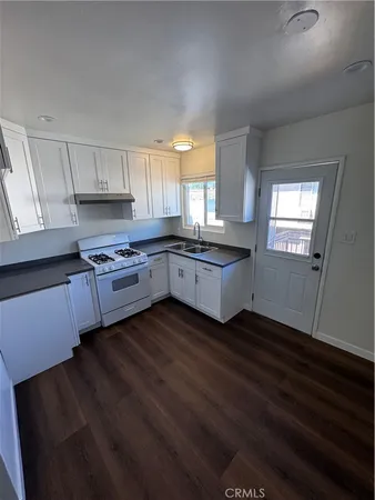 a kitchen with granite countertop stainless steel appliances and wooden cabinets