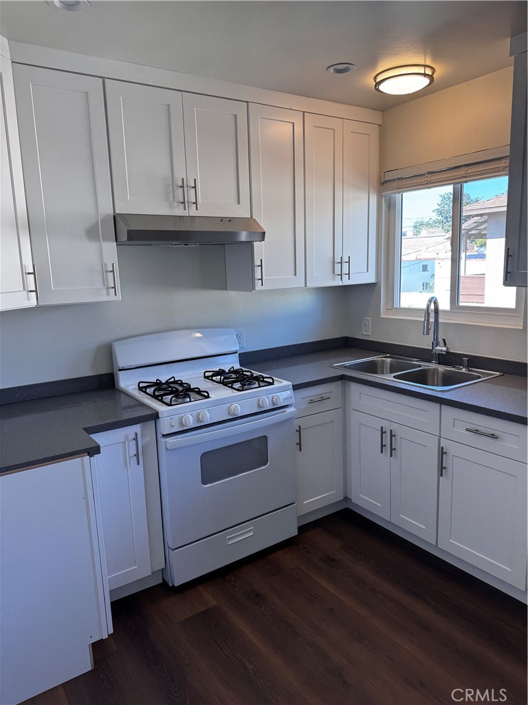 1357 Orange Grove Avenue, Unit A Glendale, CA 91205 - Photo 2 of 17 a kitchen with granite countertop white cabinets and a stove