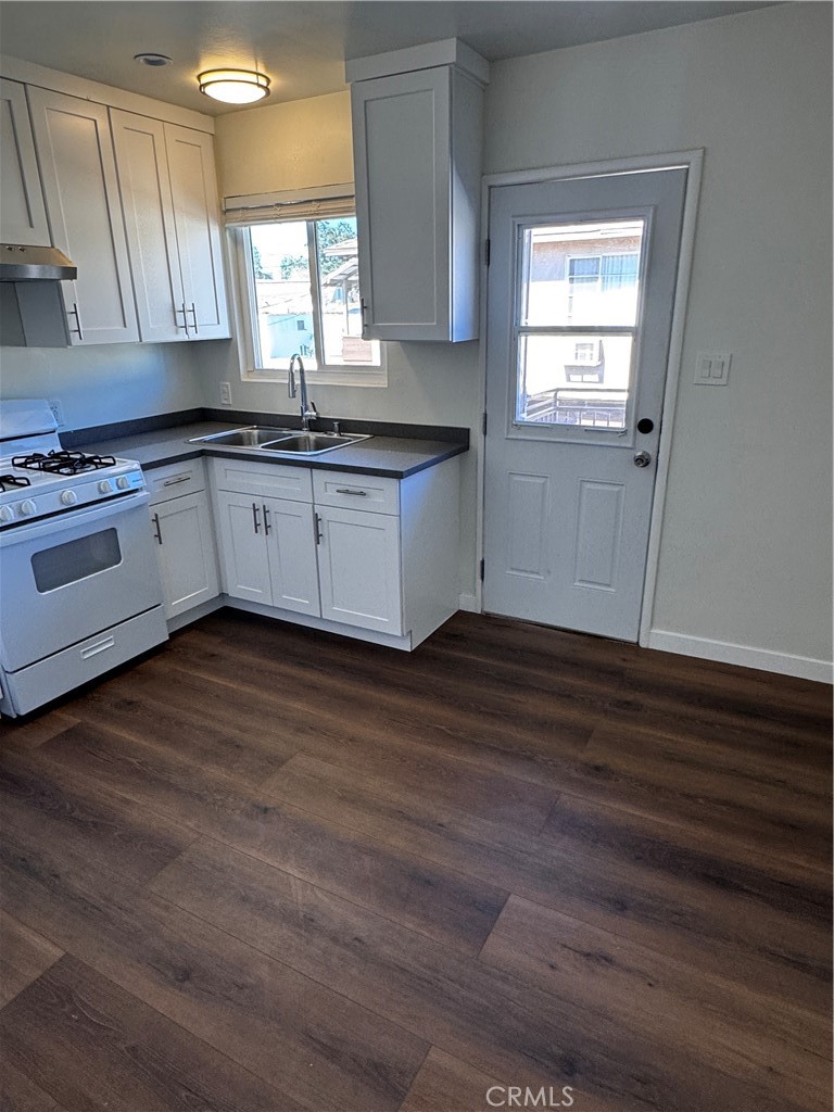 1357 Orange Grove Avenue, Unit A Glendale, CA 91205 - Photo 3 of 17 a kitchen with granite countertop wooden floors stainless steel appliances and window