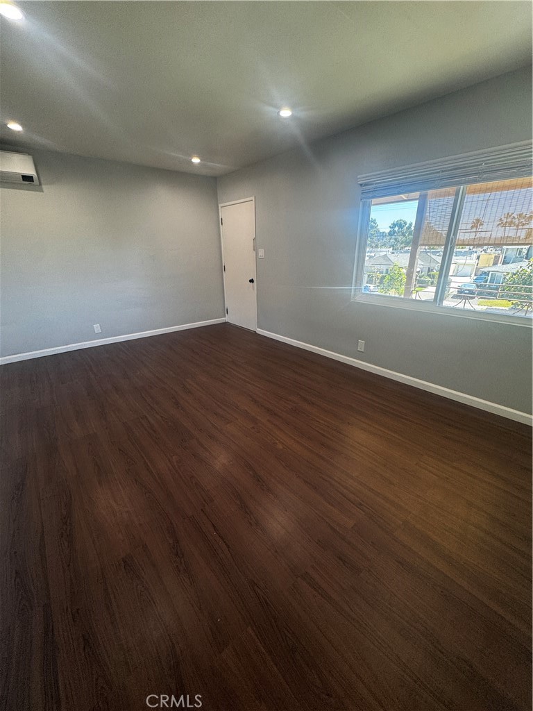 1357 Orange Grove Avenue, Unit A Glendale, CA 91205 - Photo 4 of 17 an empty room with wooden floor and windows