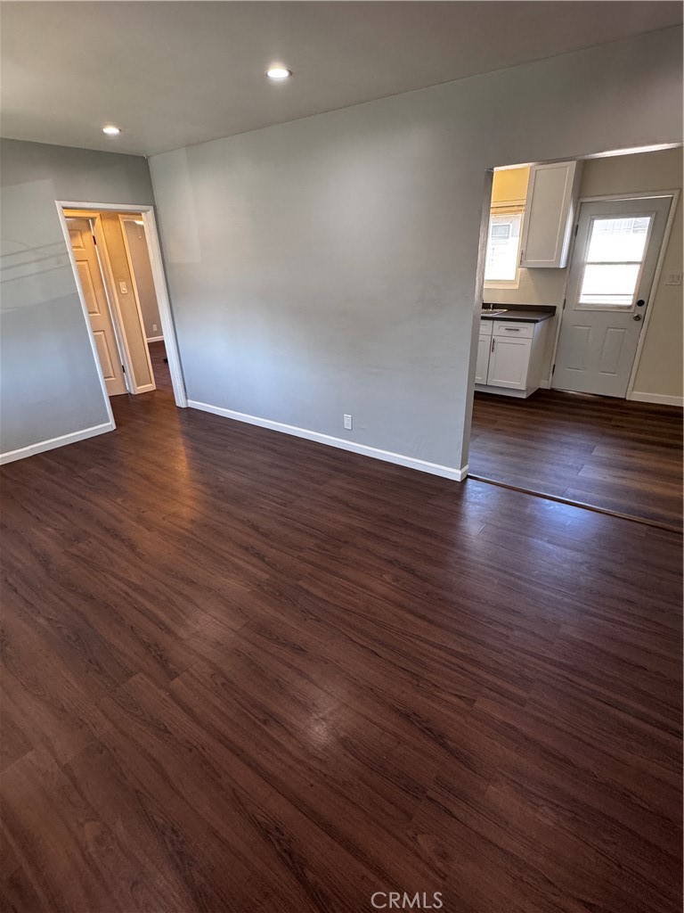 1357 Orange Grove Avenue, Unit A Glendale, CA 91205 - Photo 5 of 17 an empty room with wooden floor and windows