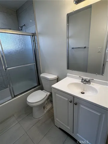 a bathroom with a toilet sink and shower