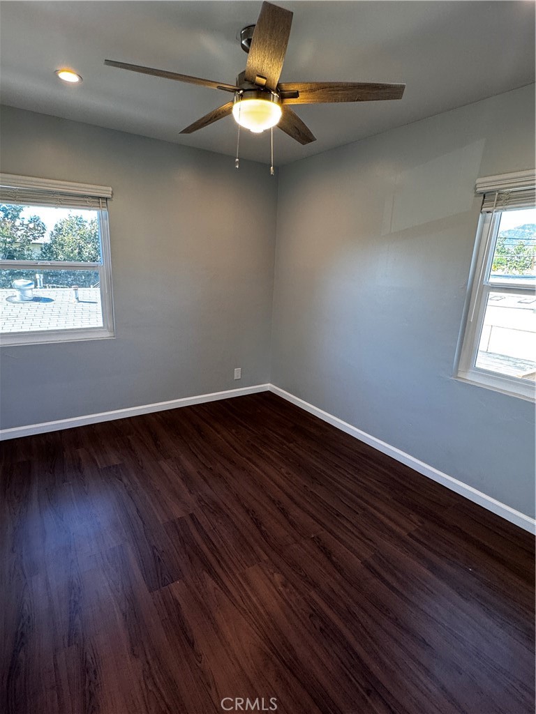 1357 Orange Grove Avenue, Unit A Glendale, CA 91205 - Photo 10 of 17 an empty room with wooden floor chandelier fan and windows