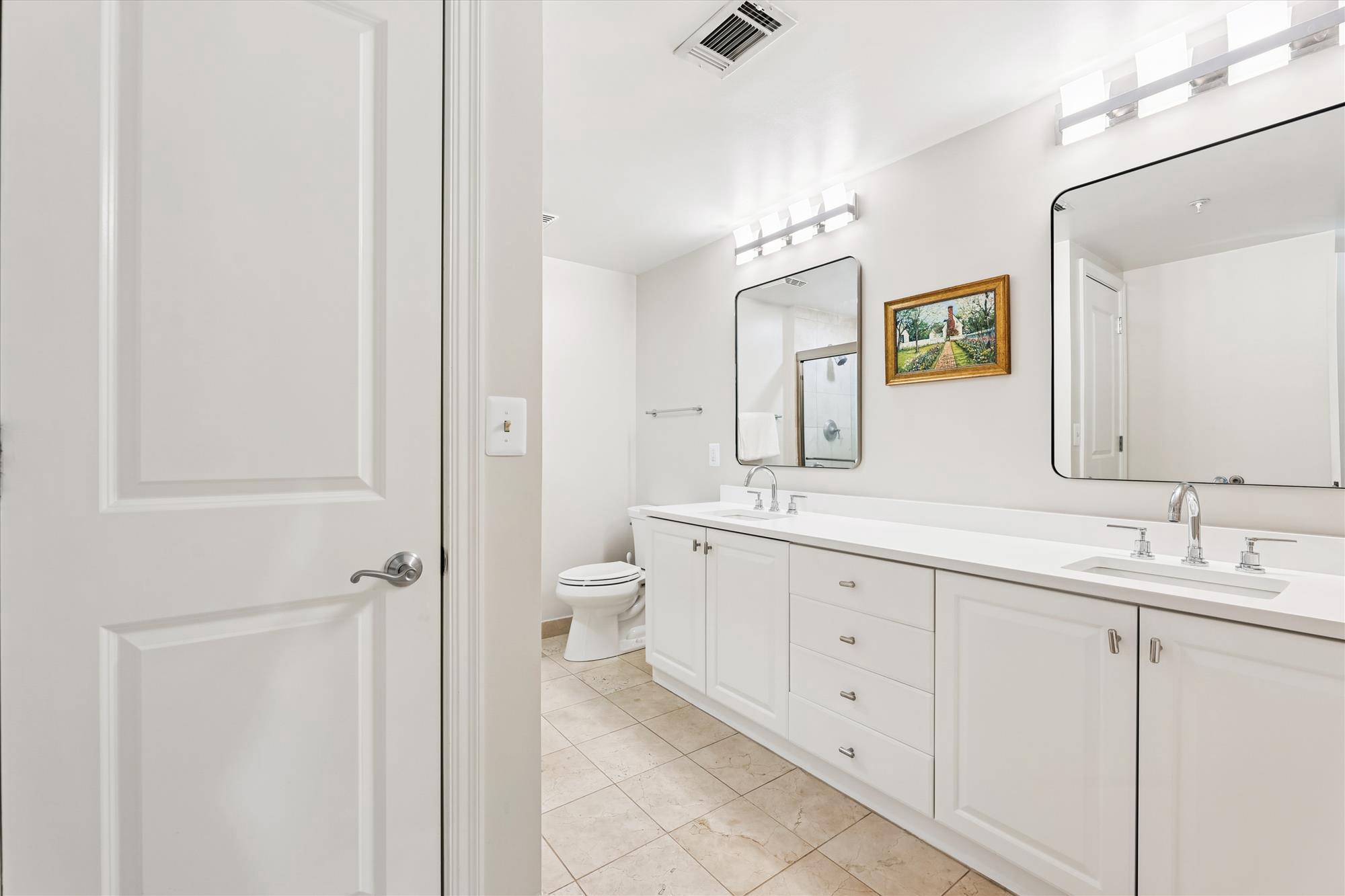 2501 Wisconsin Avenue Northwest, Unit 7 Washington, DC 20007 - Photo 11 of 28 a spacious bathroom with a double vanity sink a mirror and a toilet