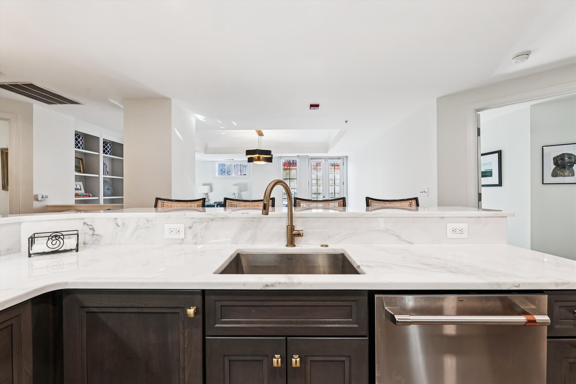 2501 Wisconsin Avenue Northwest, Unit 7 Washington, DC 20007 - Photo 17 of 28 a view with kitchen island a sink and wooden floor