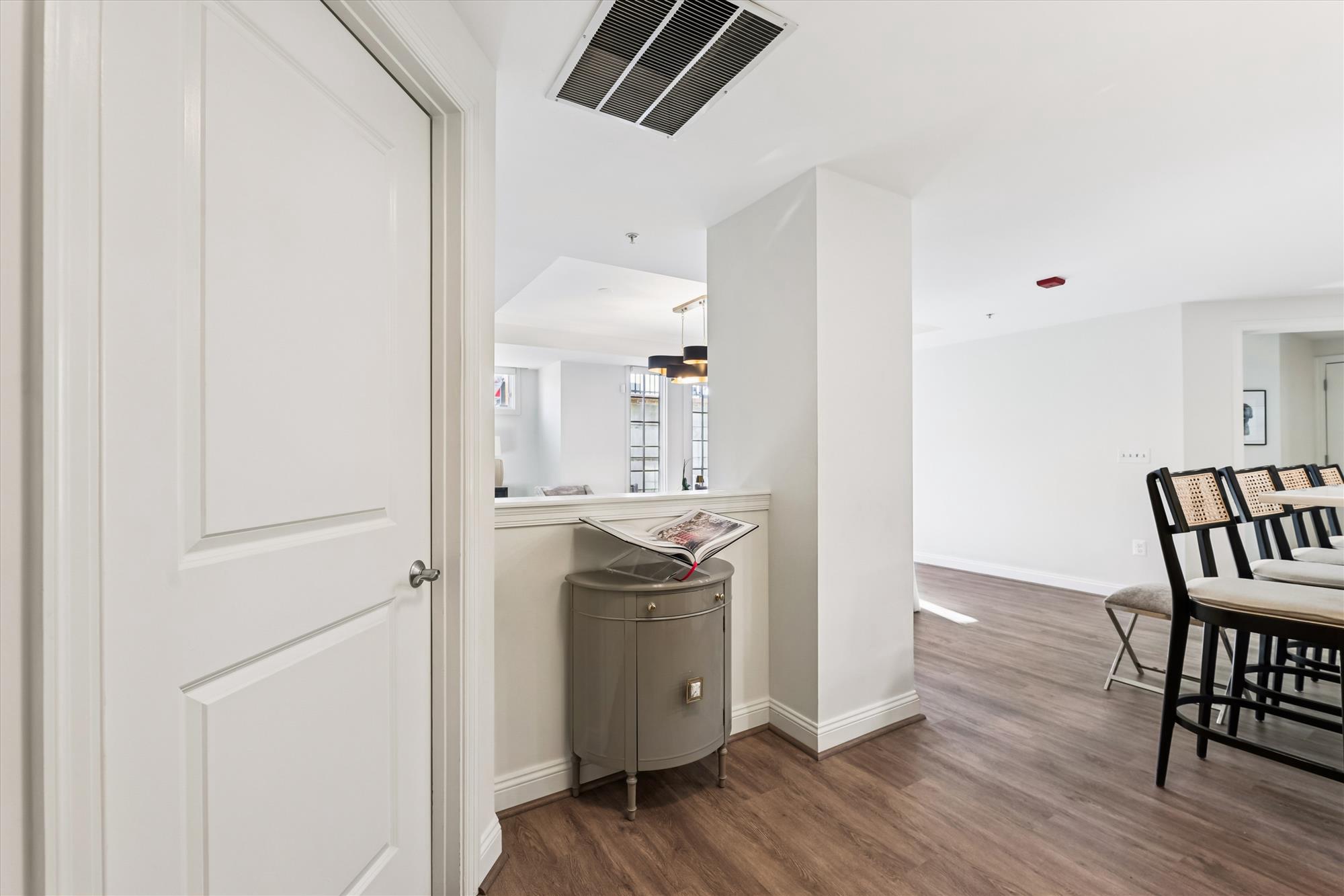 2501 Wisconsin Avenue Northwest, Unit 7 Washington, DC 20007 - Photo 20 of 28 a kitchen with a wooden floor and white appliances