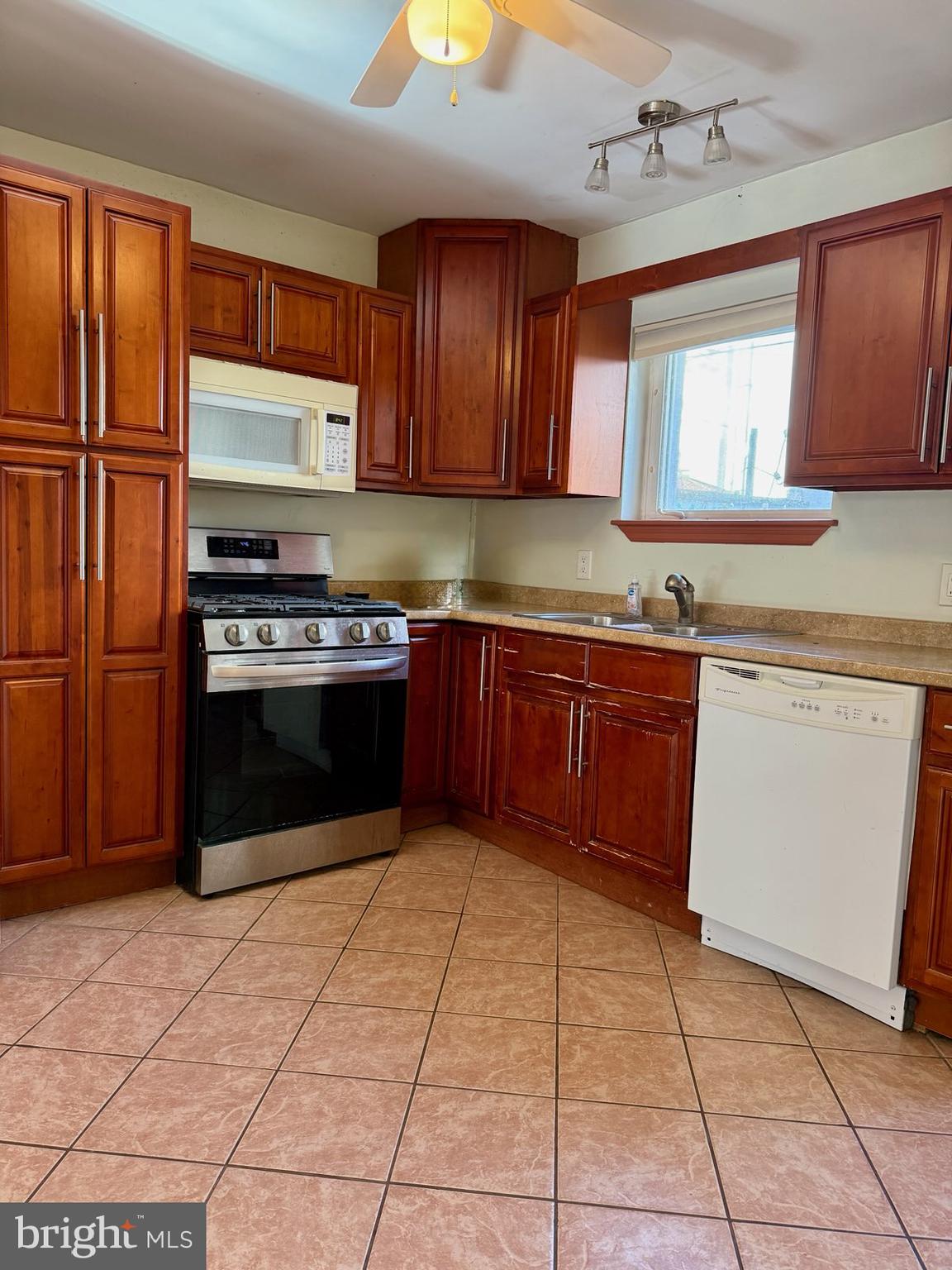 811 Earp Street Philadelphia, PA 19147 - Photo 11 of 29 a kitchen with stainless steel appliances granite countertop a stove top oven a sink dishwasher and a refrigerator