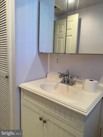 a bathroom with a sink vanity and a mirror