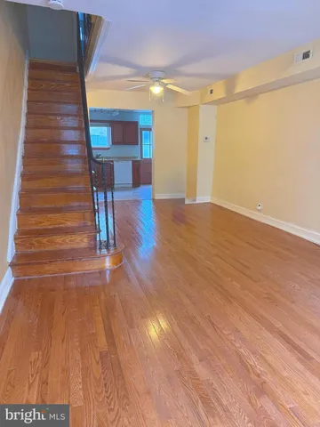 a view of a room with wooden floor