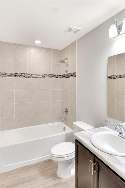 961 Inverness Way Lake Lake Alfred, FL 33850 - Photo 12 of 22 a bathroom with a granite countertop bathtub sink vanity mirror and toilet