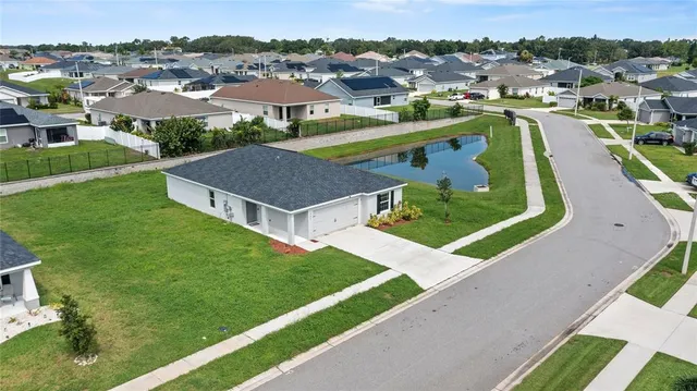 an aerial view of a house with a ocean view