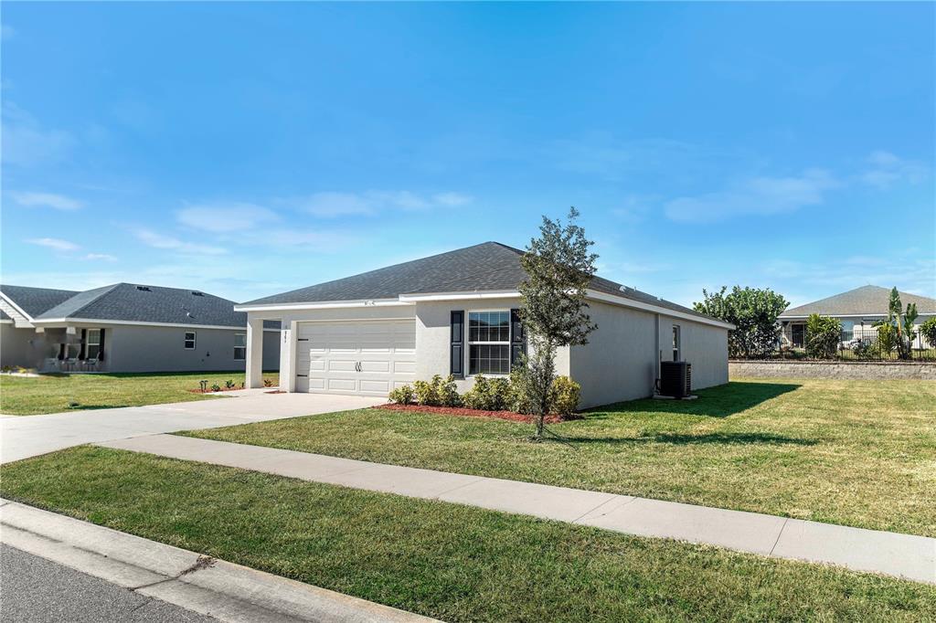961 Inverness Way Lake Lake Alfred, FL 33850 - Photo 2 of 22 a front view of a house with a yard