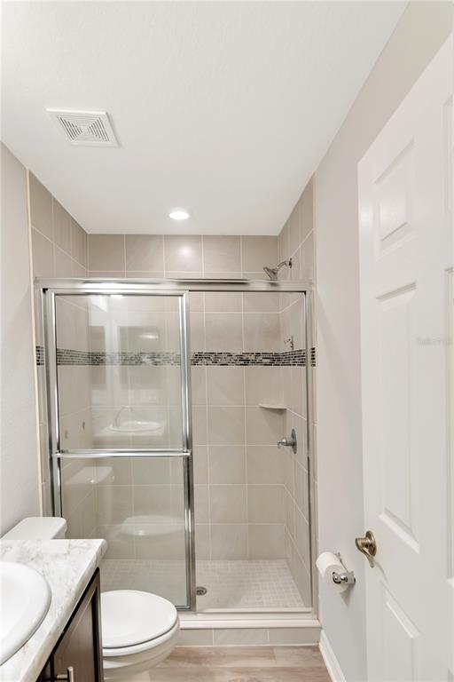 961 Inverness Way Lake Lake Alfred, FL 33850 - Photo 10 of 22 a bathroom with a granite countertop bathtub shower sink vanity and toilet