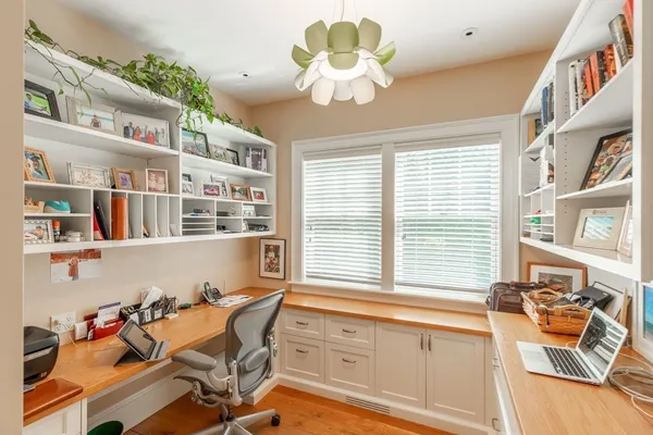 a dining room with furniture and a large window