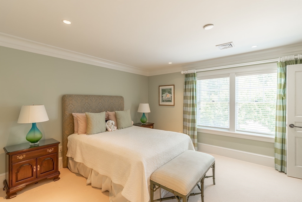 19 High Ridge Drive Mattapoisett, MA 02739 - Photo 20 of 30 a bedroom with a bed and a lamp on table