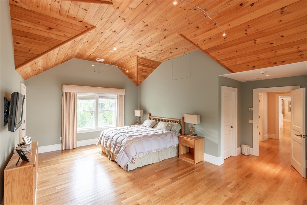 19 High Ridge Drive Mattapoisett, MA 02739 - Photo 24 of 30 a bedroom with a bed and a flat tv screen on wall