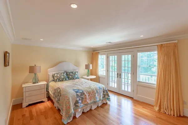 a bedroom with a bed and a large window