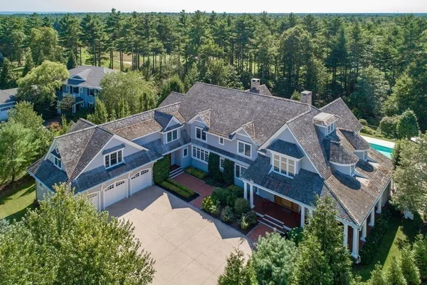 an aerial view of house with yard and outdoor seating