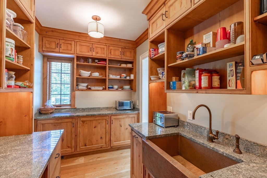 19 High Ridge Drive Mattapoisett, MA 02739 - Photo 10 of 30 a kitchen with kitchen island granite countertop a sink and a stove top oven with wooden floor