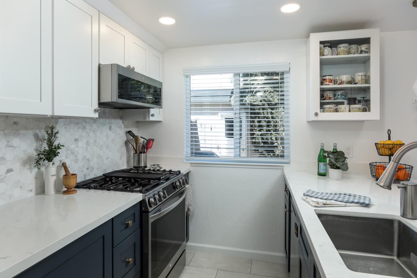 1394 North Loop Drive San Jose, CA 95126 - Photo 12 of 40 a kitchen with stainless steel appliances a stove a microwave a sink and cabinets