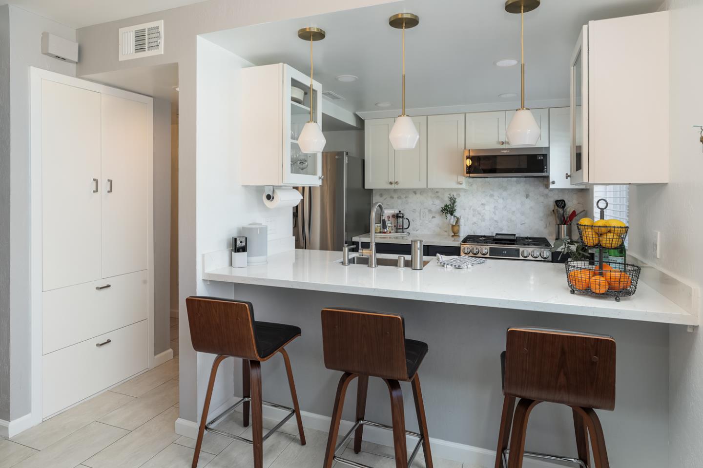 1394 North Loop Drive San Jose, CA 95126 - Photo 10 of 40 a kitchen with stainless steel appliances a white table chairs refrigerator and sink