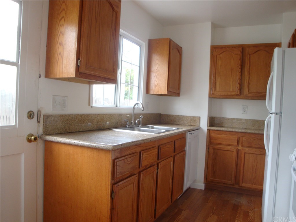 a kitchen with a sink a window and cabinets