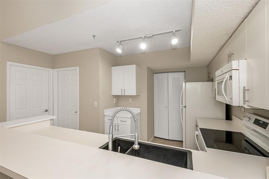 3848 Lyons Road, Unit 202 Coconut Creek, FL 33073 - Photo 12 of 32 a kitchen with stainless steel appliances a refrigerator and a stove