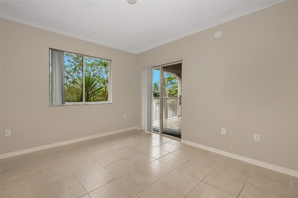 3848 Lyons Road, Unit 202 Coconut Creek, FL 33073 - Photo 16 of 32 an empty room with windows