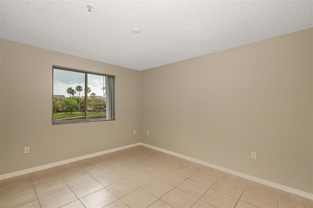 3848 Lyons Road, Unit 202 Coconut Creek, FL 33073 - Photo 22 of 32 a view of an empty room with a window