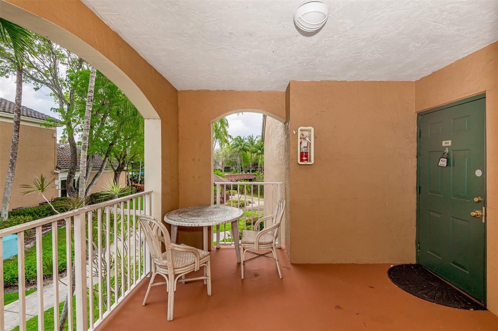 3848 Lyons Road, Unit 202 Coconut Creek, FL 33073 - Photo 31 of 32 a view of a room with furniture and a window